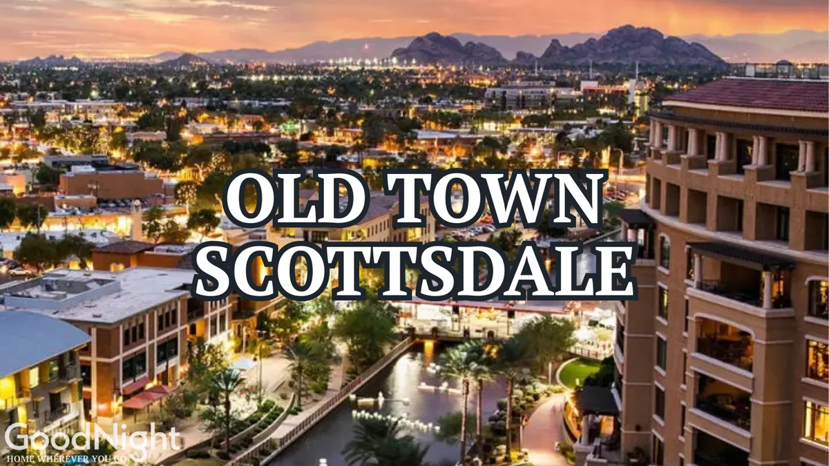 This image captures the iconic Old Town Scottsdale sign set against a backdrop of city lights and mountains. The scene is vibrant and energetic, with people strolling along the waterfront and outdoor cafes bustling with activity, evoking the nightlife and lively downtown atmosphere described in the section.